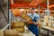 Bicycle factory, worker takes box from the shelf