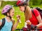 Bicycle girls cycling eating ice cream cone in park.