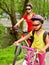 Bicycle girls with rucksack cycling on bike lane.