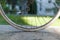 Bicycle half wheel on old dark green Italian woman bike with light green lawn