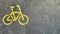 Bicycle icon in the left. Bicycle parking area with bicycle sign on top of the asphalt in the middle of the park