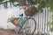 Bicycle Leaning on a White Picket Fence