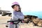 Bicycle little happy girl pink helmet in rocky sea