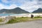 Bicycle with luggage stands in front of dramatic mountains at a