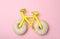 Bicycle made with donuts and paper on background, top view