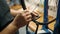 A bicycle mechanic fixes and adjusts the spoke tension on cycle bike wheel in a repair shop