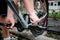 Bicycle mechanic hands adjusts cycling pedals