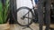 Bicycle mechanic puts bike on rack in bike workshop. Bicycle repairing. Repair shop