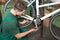 Bicycle mechanic repairing tooth belt in a workshop