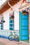 Bicycle next to a beautiful blue and white house at Guatape