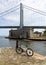 Bicycle on an old stone pier, Battery Weed and Verrazzano Bridge in the background, Staten Island, NY, USA