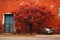 a bicycle is parked next to a red tree