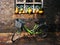 A bicycle parked next to the window sill filled with pumpkins