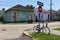 Bicycle parked at a stop sign in front of a row of colorful houses in a street of the city of New Orleans in Louisiana.