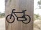 Bicycle path through the park, the sign on a wooden landmark