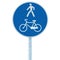 Bicycle and pedestrian lane road sign on pole post, large blue round isolated bike cycling walking walkway footpath trail route