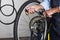 Bicycle Repair. Closeup. of a bike repairman pumping up a tire in his workshop