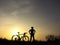 Bicycle rider stand on the hill watching the sunlight and relax