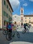 Bicycle riders in front of the church of San Francesco, San Quir