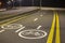 Bicycle Road Markings and Signs. Illuminated bicycle lane travel lane reserved for bicyclists with pavement markings with arrows