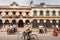 Bicycle and rushing motorcycles on historical street of indian city