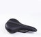Bicycle saddle black on white background, close-up view, studio photo. Vertical orientation