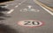 Bicycle and speed limit signs on asphalt path