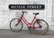 Bicycle Street Sign and Red Bike