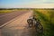 Bicycle tourism. Mountain bikes on a evening sunny light at the edge of the road, fields and landscape. Active rest on vacation