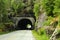 Bicycle tourist entering a tunnel, Norway