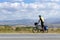 Bicycle traveler stops and enjoys endless mountain valley