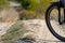 Bicycle wheel on a dirt road background. Cycling