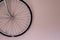 Bicycle wheel hanging on the wall with copy space. Wall mounted bike storage in the apartment