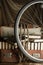 Bicycle wheel and old torn suit-case full of books