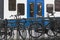 Bicycles attached to bridge railing and a tram