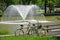 Bicycles next to a fountain in the pond