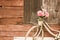 Bicycles old vintage flowers in a basket. Parked on the sidewall of the wooden house ideal for design work Classic hoodie style