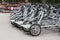 Bicycles for rent steel black pedal. Parked rental tourist trike vehicles velomobiles. Ecological urban transport