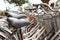 Bicycles in a row parked in bike rack or rental shop, close up