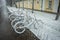 Bicycles smoothly covered with fresh snow after weather phenomena - snowfall in late April near Moscow