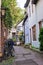 Bicycles and trees in cozy backyard. Summer patio with bikes. Bicycles in front of old house. Traditional exterior in Europe.