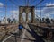 Bicyclist crossing empty Brooklyn Bridge during the coronavirus COVID-19 pandemic lockdown in New York City