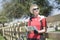 Bicyclist Holding Roadmap While Leaning On Fence