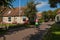 Bicyclist and old houses in Hollum village, Ameland, Netherlands