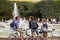 Bicyclists chat in front of fountain in Palais Royal garden in P