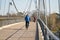 Bicyclists on the Herrenkrugsteg suspension bridge on their way across the Elbe to Herrenkrugpark