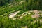 Bicyclists ride on hill slope trail park surrounded by forest