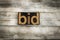 Bid Letterpress Word on Wooden Background