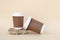 Bidegradable paper brown coffee cups with biodegradable white lids.