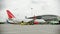 A big airplane standing on the airport field - baggage loading